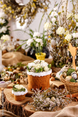 Traditional Russian Easter cakes Kulich, with eggs on a vintage wooden background.