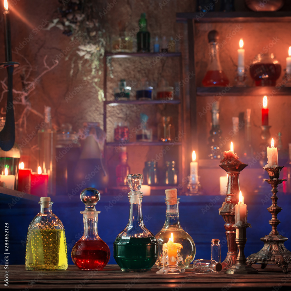 magic potions in bottles on wooden background magic potions in bottles on wooden background