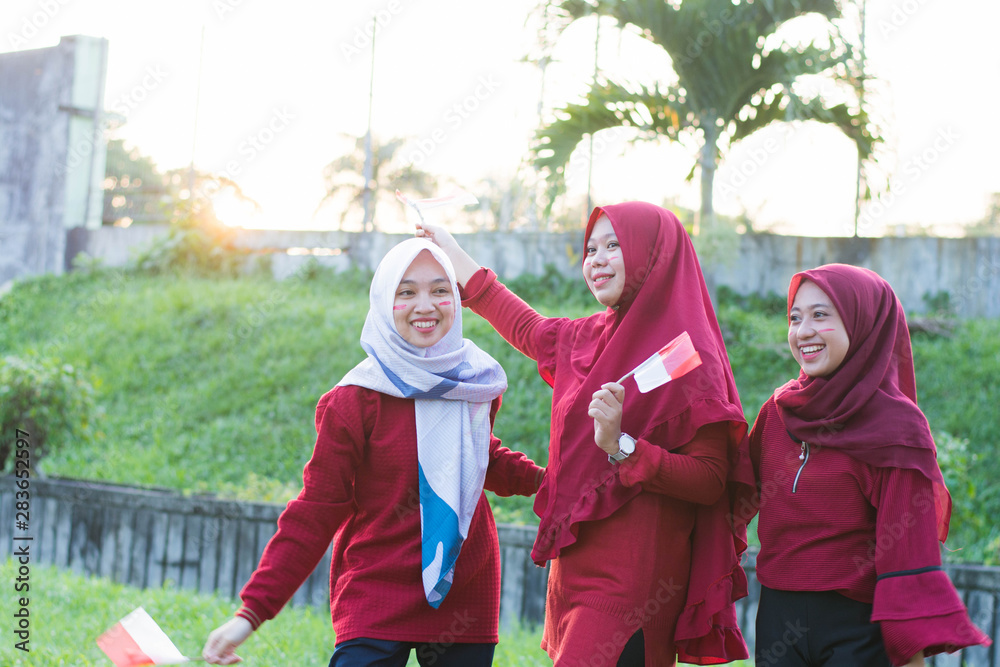 portrait of young asian muslim woman group with indonesian flag celebrate indonesian independence day