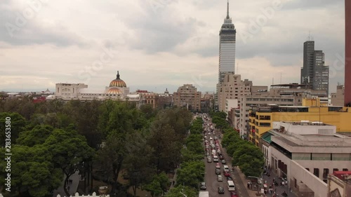 Aerial view of the traffic in Av. Juárez in México City during rush hour. Drone flying forward above the cars with the city skyline as background.