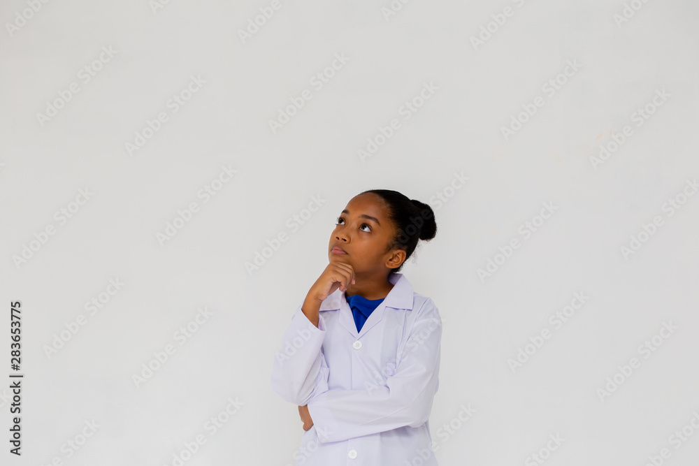 Young preteen African American kid wearing lab coat thinking and questioning in white isolated background Young preteen African American kid wearing lab coat thinking and questioning in white isolated background