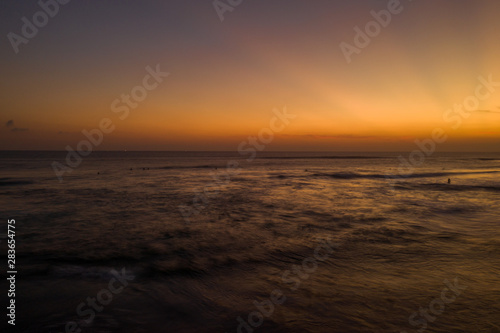 Aerial drone view of the sea over beautiful golden sunset sky background © stryjek