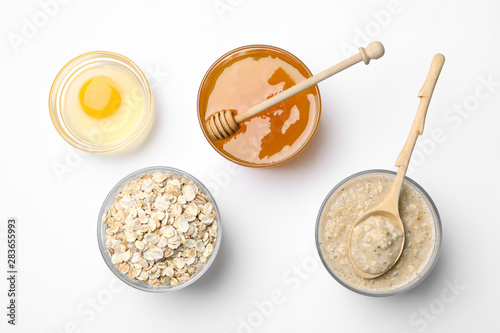 Composition of handmade face mask and ingredients on white background, top view