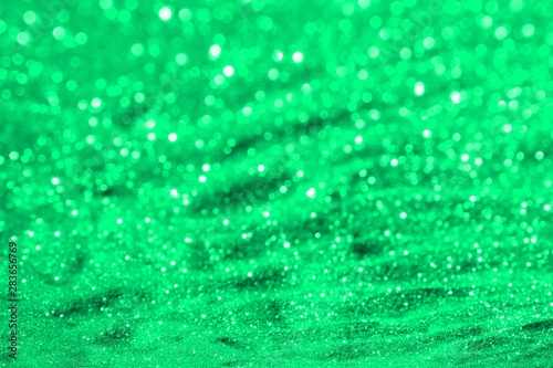 teal, sea-green glossy metallic sand made of glitters - bright concept with bokeh texture - fantastic abstract photo background