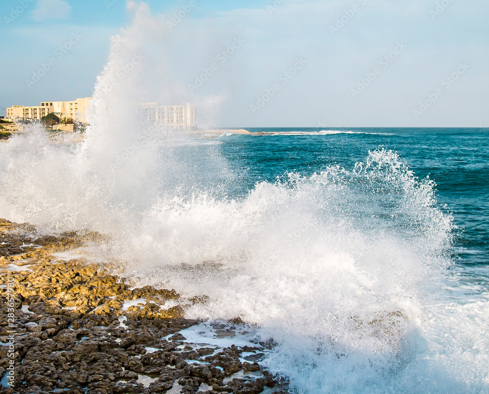 Sea Waves crashing on rocky coast as background