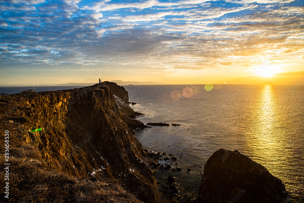 Lighthouse on Rocky Cliffs Above Ocean at Sunrise - 4