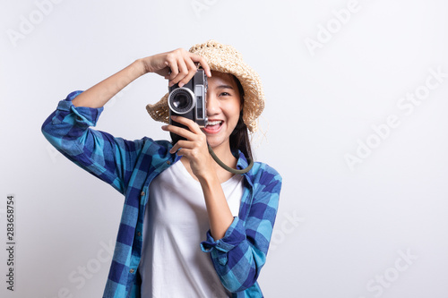 tourist Beautiful of Asian woman holding a film camera and smiling isolated on white background, Asia girl wear Plaid shirt and wear Straw hat, Summer concept