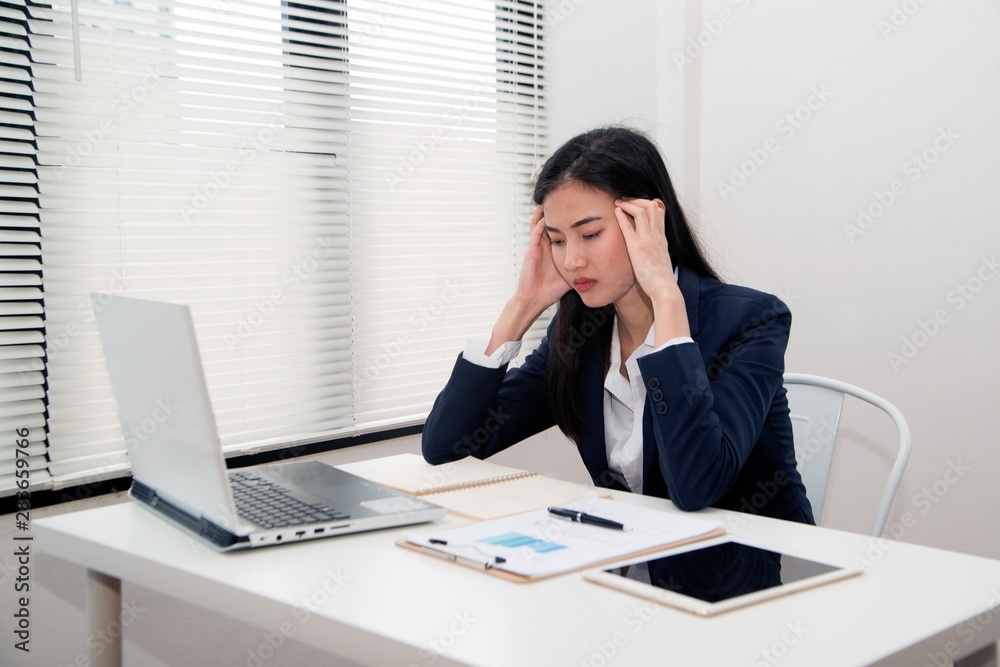 Asian Young beautiful business woman suffering stress working at office from feeling tired and desperate looking overworked and overwhelmed and frustrated. . Asian Young beautiful business woman suffering stress working at office from feeling tired and desperate looking overworked and overwhelmed and frustrated. .