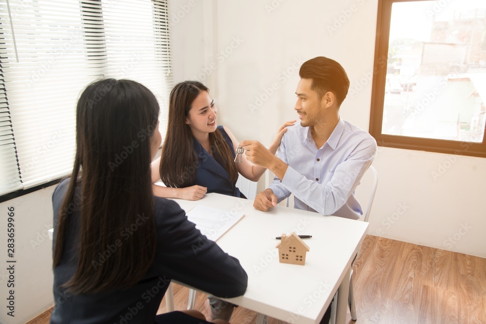 Picture of a serious Asian female salesman Sit in a modern office room and talk to customers and be satisfied with success. Picture of a serious Asian female salesman Sit in a modern office room and talk to customers and be satisfied with success.
