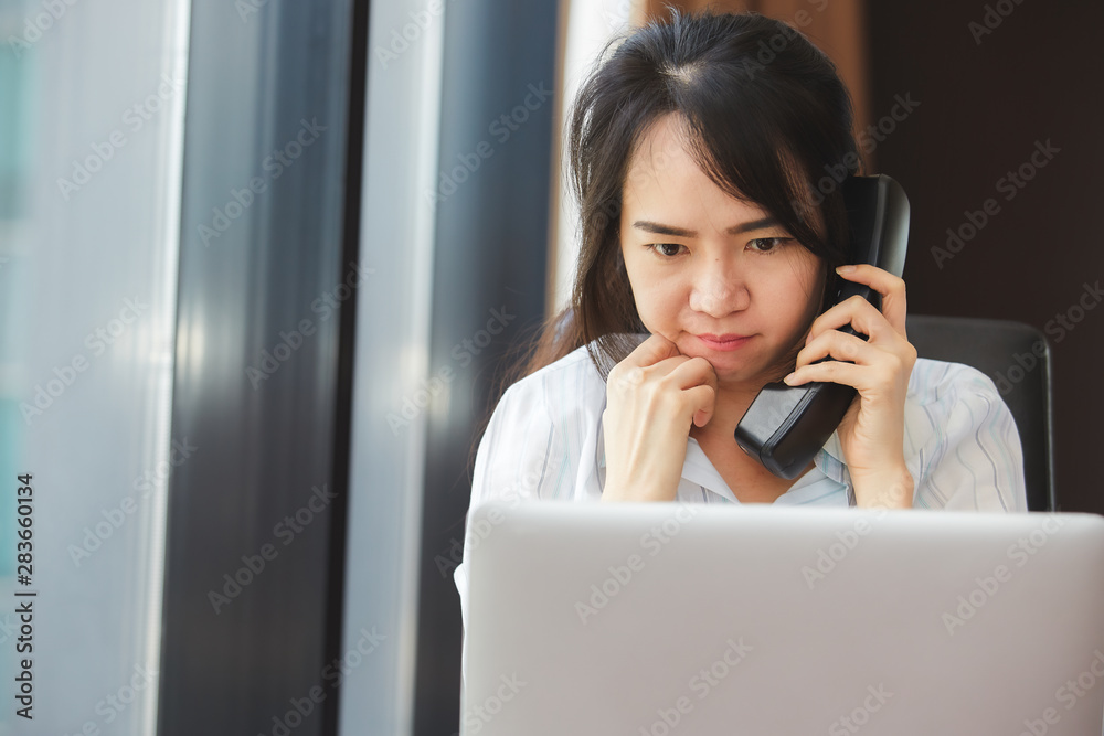 Happy asian business woman talking the phone at the working place. Happy asian business woman talking the phone at the working place.