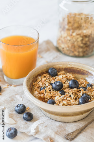bowl of granola cereal with blueberries and juice healthy breakfast
