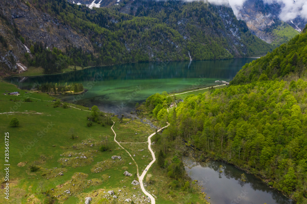 Scenic mountain panorama with green meadows and idyllic turquoise Lake Oberer