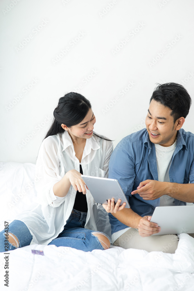 Surprising Asian couple using laptop at home, lifestyle concept. Surprising Asian couple using laptop at home, lifestyle concept.