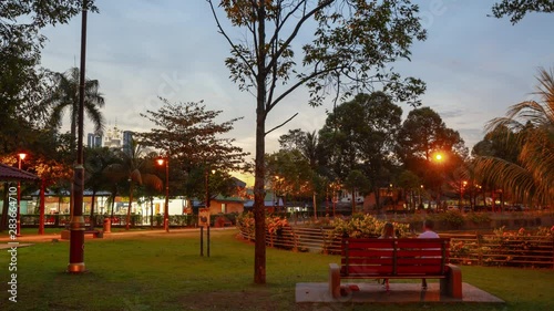 sunset time illuminated kuala lumpur city public park downtown view panorama 4k timelapse malaysia  photo