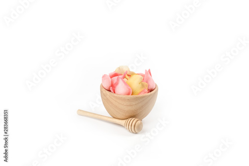 Pink rose flower in wood bowl on white background.