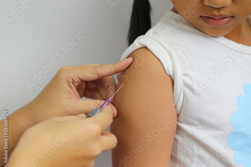 Close-up of doctor making vaccination to the patient on white background,Healthy concept