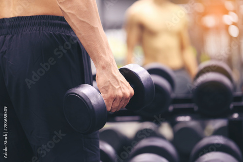 Man training hand holding dumbbells for burn fat in the body in the sport gym, Healthy lifestyle and sport concept