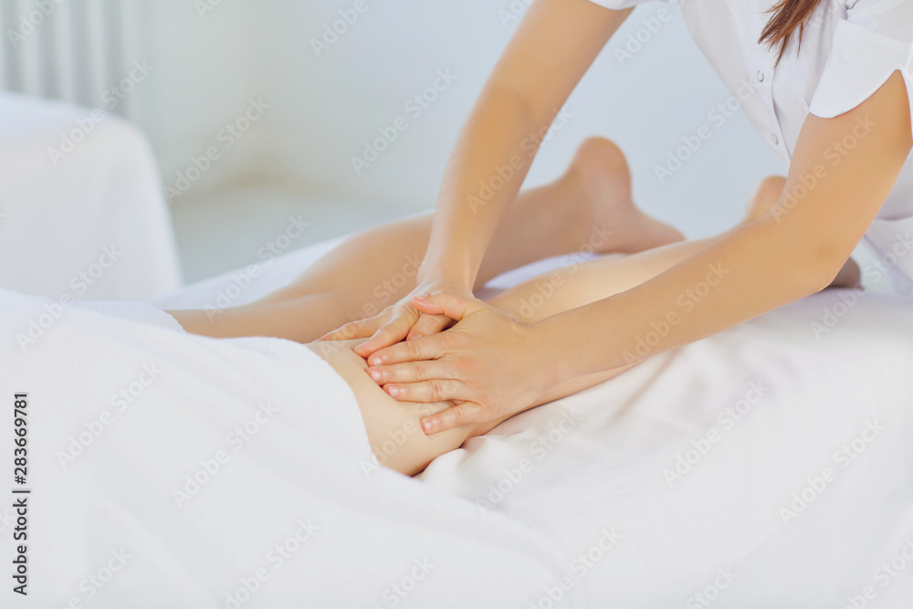 Woman having massage leg at spa salon. Woman having massage leg at spa salon.