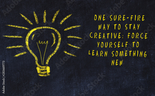 Chalk drawing of bulb and inscription about art and creativity photo