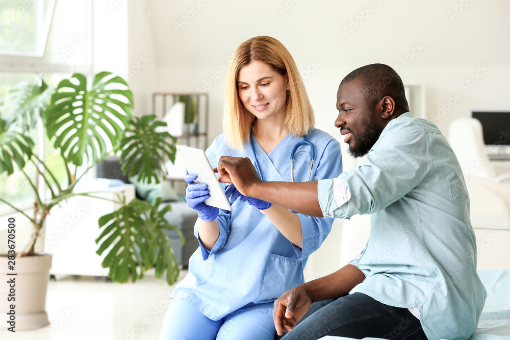 Fototapeta premium African-American man meeting with plastic surgeon in clinic