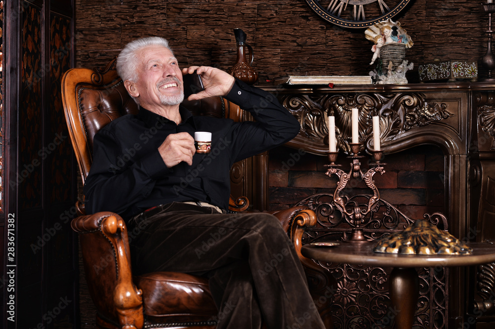 Portrait of smiling senior man drinking coffee Portrait of smiling senior man drinking coffee