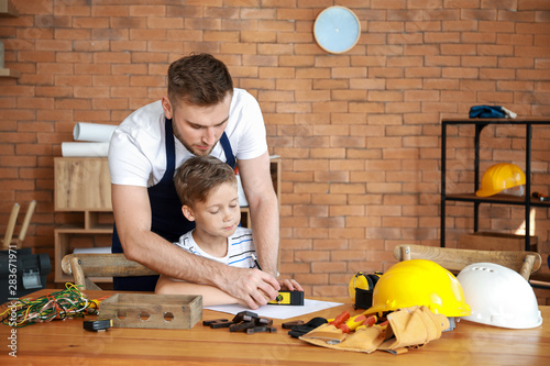 Father teaching his little ...