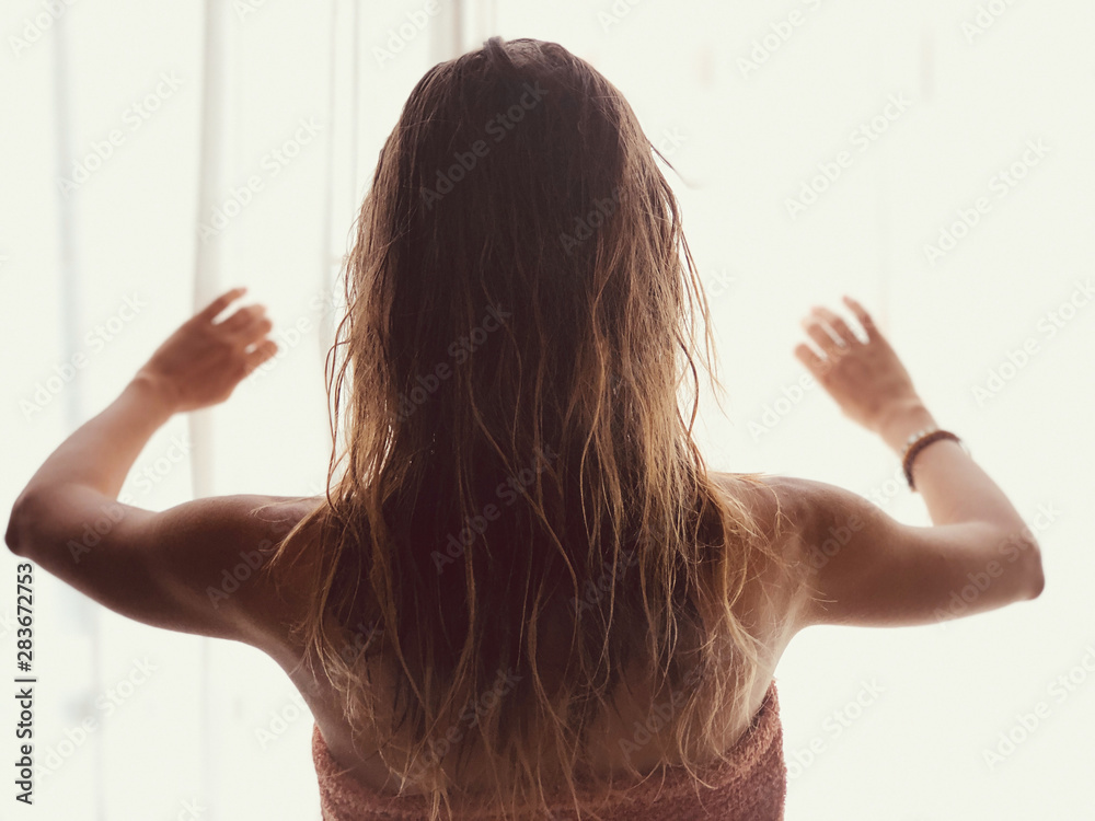Silhouette of a girl while waking up in the room and holding curtain. Silhouette of a girl while waking up in the room and holding curtain.