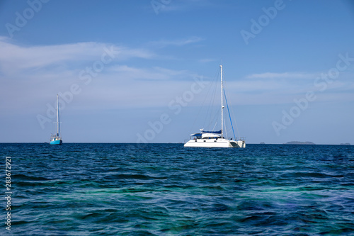 White yachts sailing in tropical sea