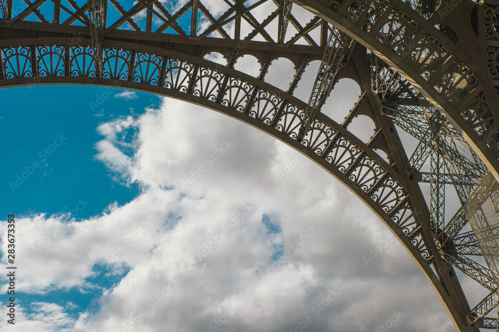 Eiffel tower with blue sky in a cloudy day Eiffel tower with blue sky in a cloudy day