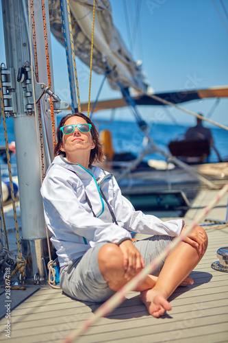 Young woman enjoying on a sailing boat.