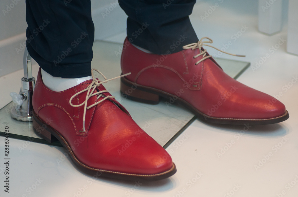 closeup of red leather shoes for men in fashion store showroom closeup of red leather shoes for men in fashion store showroom