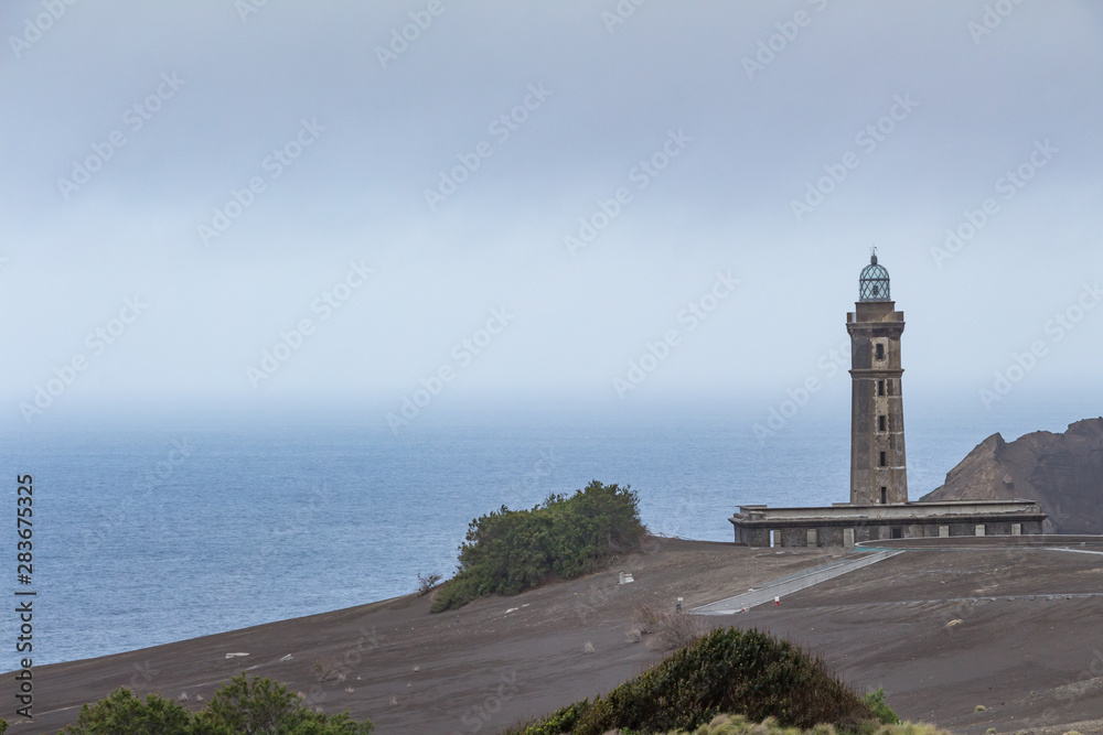 View over Capelinhos volcano, lighthouse of Ponta dos Capelinhos on western coast on Faial island, Azores, Portugal. Last volcano eruption was in 1957.