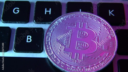 Circle Bitcoin coin on top of computer keyboard buttons. Digital currency, block chain market, online business photo