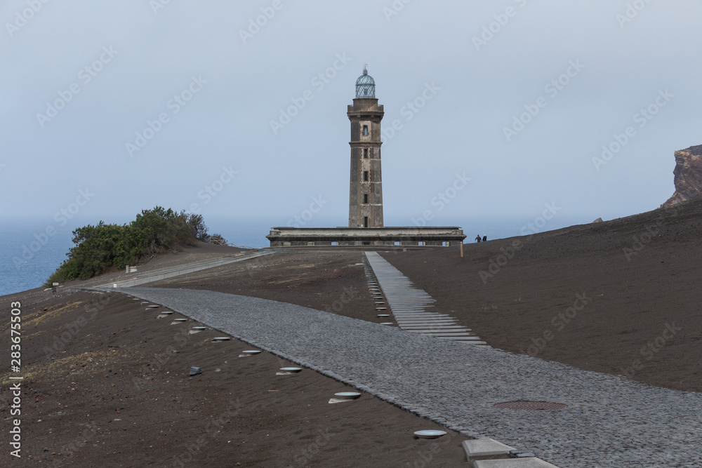 Lighthouse of Ponta dos Capelinhos on western coast on Faial island, Azores, Portugal. Last Capelinhos volcano eruption was in 1957.