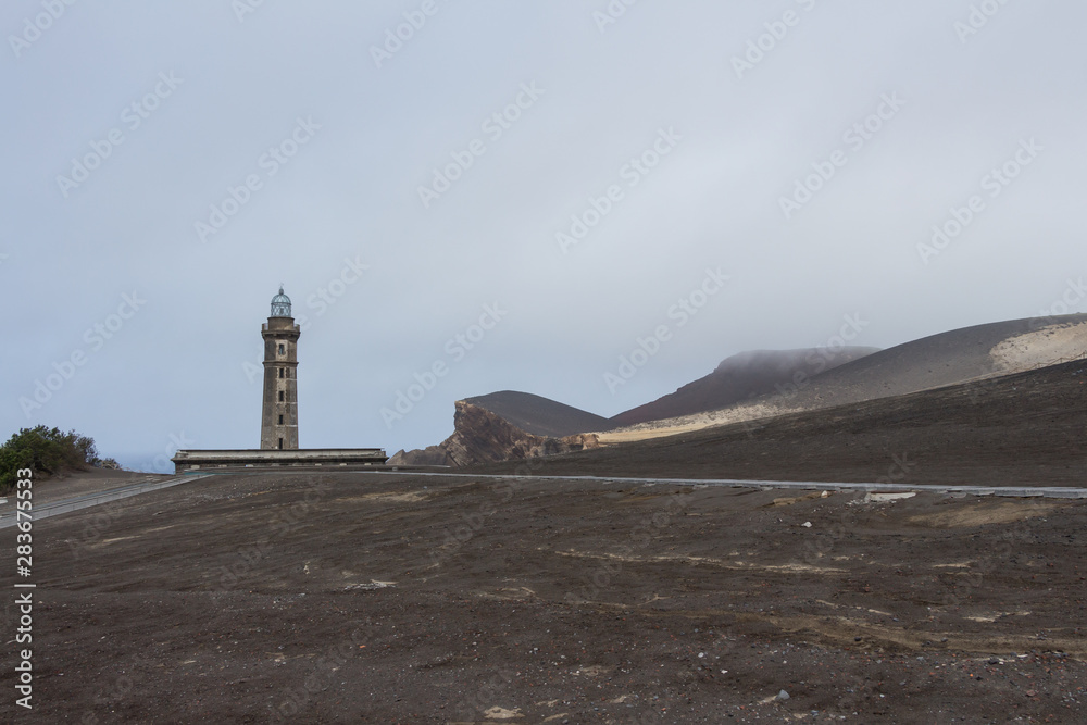 View over Capelinhos volcano, lighthouse of Ponta dos Capelinhos on western coast on Faial island, Azores, Portugal. Last volcano eruption was in 1957.