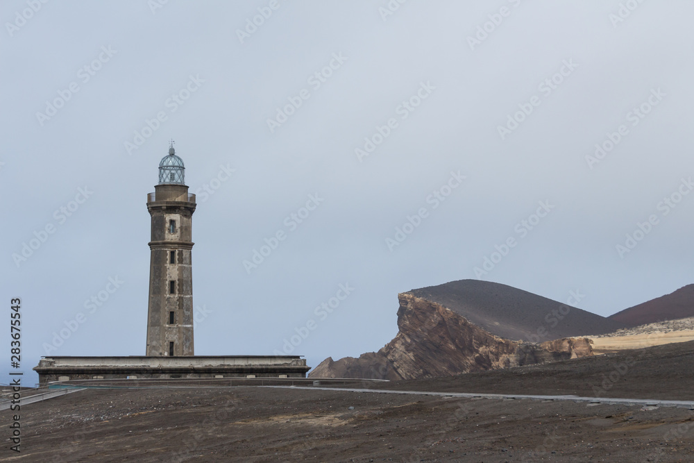 View over Capelinhos volcano, lighthouse of Ponta dos Capelinhos on western coast on Faial island, Azores, Portugal. Last volcano eruption was in 1957.
