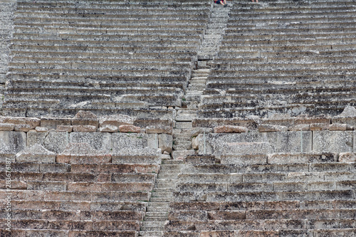 Obraz na płótnie Stairs of the ancient theatre of Epidaurus in the Epidaurus town, on Peloponnesus peninsula, Greece. The theater was dedicated to the ancient Greek God of medicine, Asclepius. Stairs closeup. w salonie