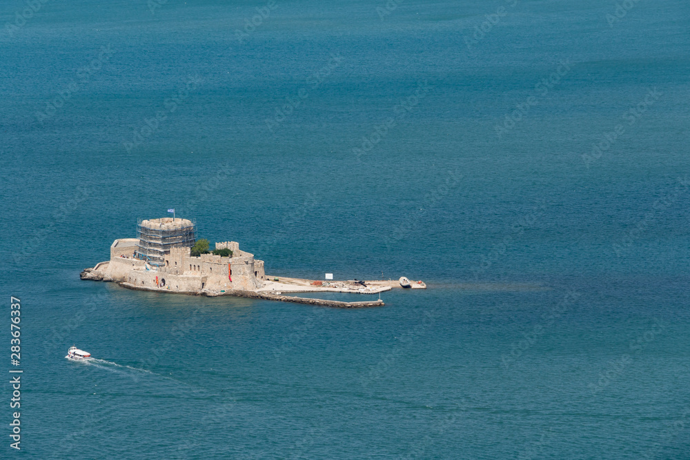 Aerial view over Bourtzi Castle on a small islet in city of Nafplio former capital of Greece, Peloponnese.