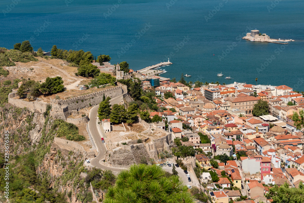Aerial view from famous Venetian Palamidi fortress and Bourtzi Castle on a small islet in the city of Nafplio former capital of Greece, Peloponnese.