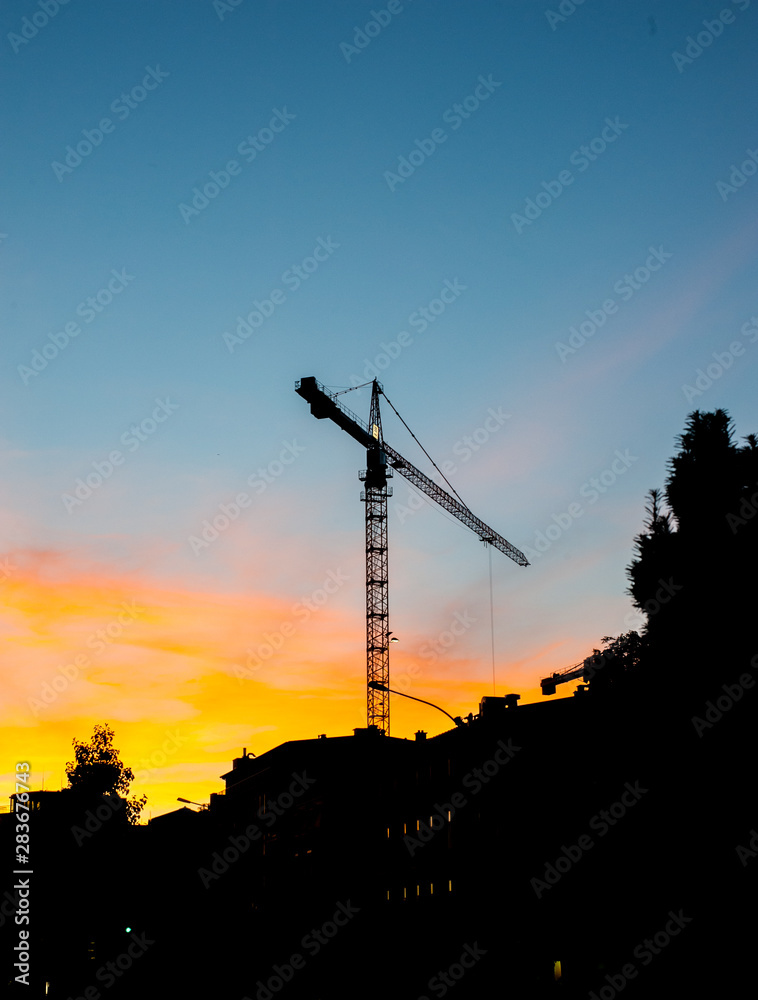 Construction cranes before the sunset Construction cranes before the sunset