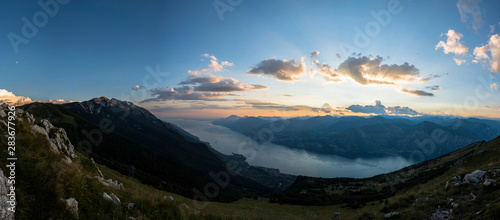 180 degrees panoramic view over lake Garda at sunset hour. Panoramic from the top of Monte Baldo