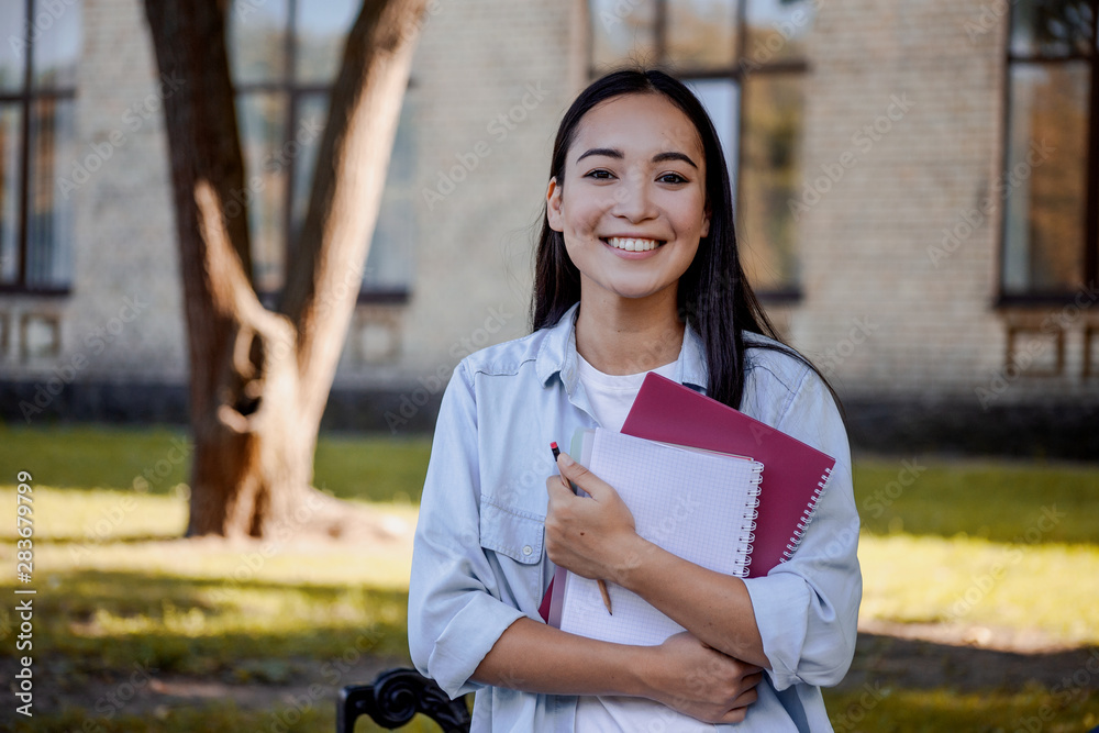 Young pretty schoolgirl in high school preparing for exams and dreaming to be a student in prestigious University. Smart clever woman, education concept. Young pretty schoolgirl in high school preparing for exams and dreaming to be a student in prestigious University. Smart clever woman, education concept.