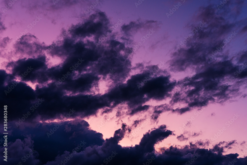 Blue hour sky clouds background. Beautiful landscape with clouds and purple sun on sky