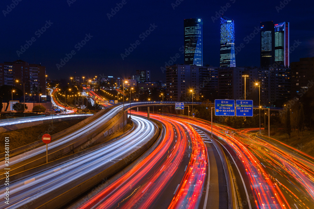 M30 highway at night with Madrid skyline (Four towers business area) as background, Spain