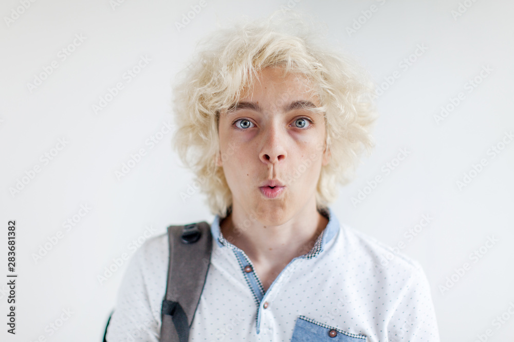 Portrait of cheerful young blond man smiling looking at camera