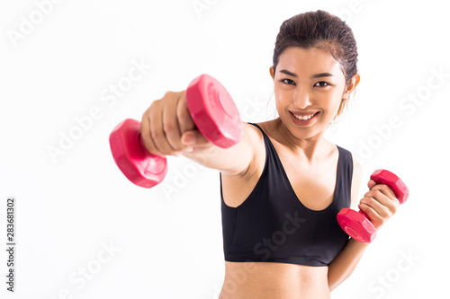 Strong young woman in crop top punching with red barbells in hands during boxing class on white background. One girl working out in studio shot.