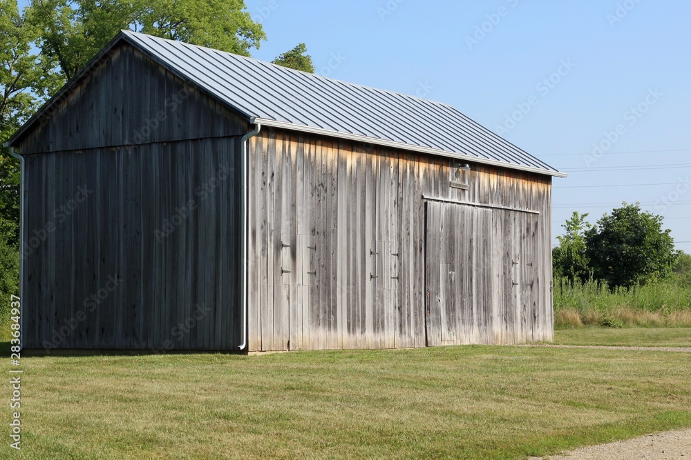 A side view of the old wood barn in the countryside. A side view of the old wood barn in the countryside.