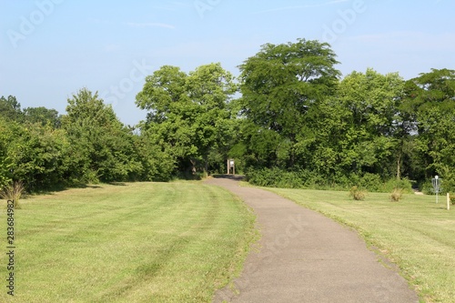 Fototapeta Naklejka Na Ścianę i Meble -  The empty pathway in the park on a sunny day.