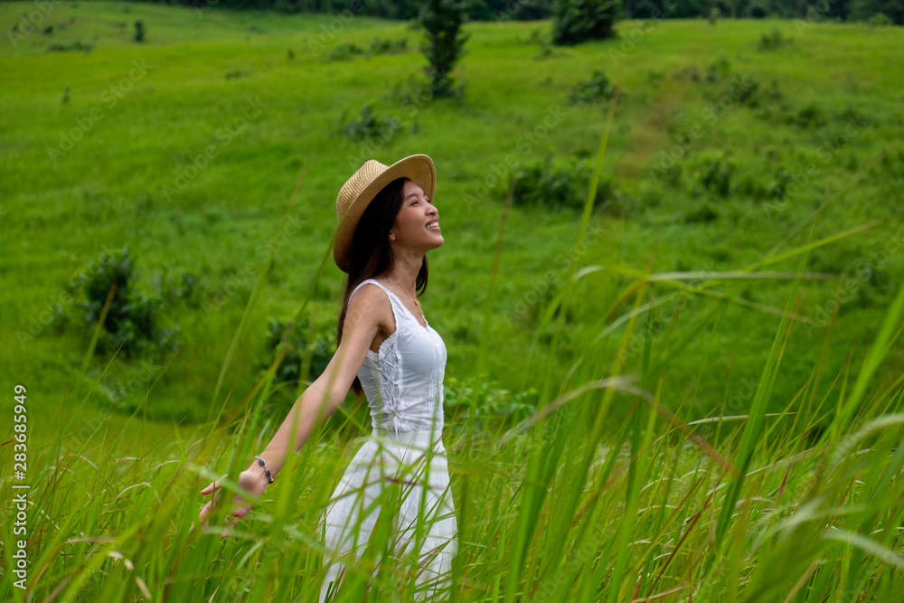 Girl breathing fresh air with white dress in a green meadow,enjoying in the sunny summer day. Girl breathing fresh air with white dress in a green meadow,enjoying in the sunny summer day.