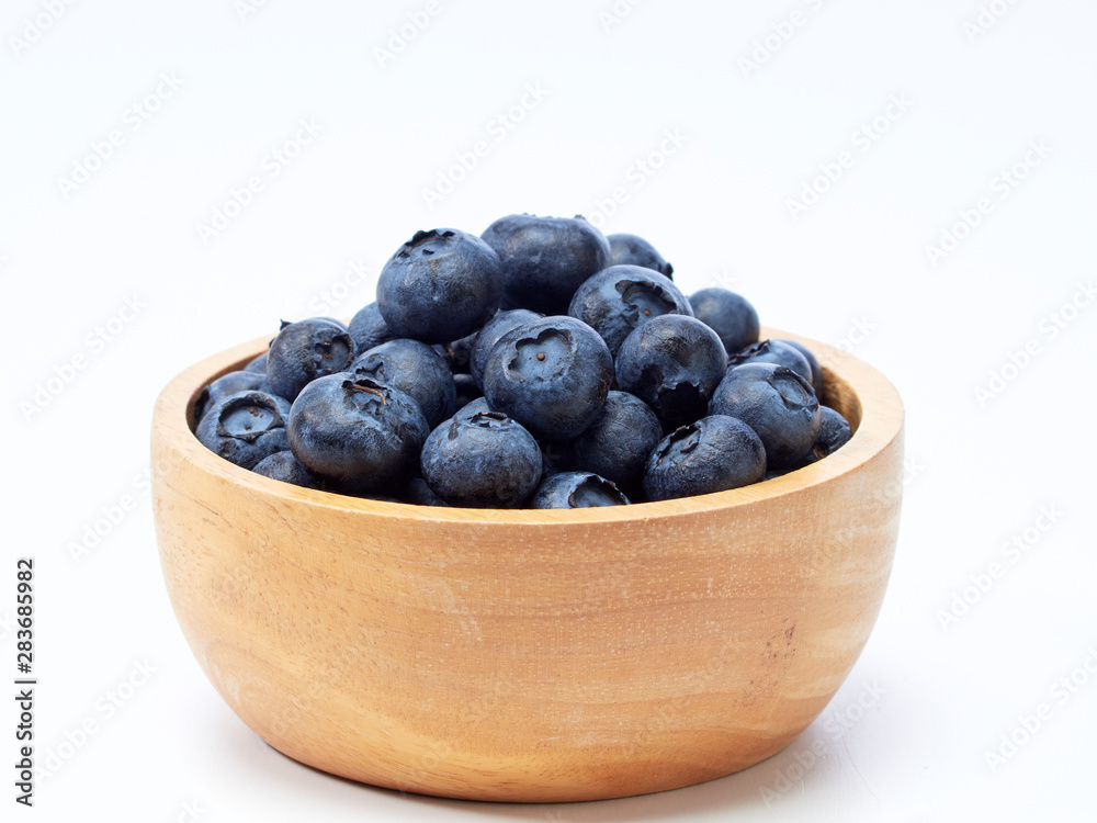 blueberry in wooden bowl on white background blueberry in wooden bowl on white background